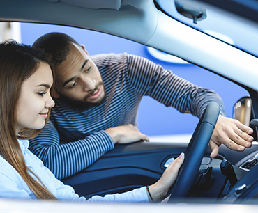 Man and woman looking at a car