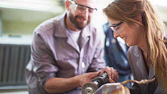 Man and woman working with safety glasses on