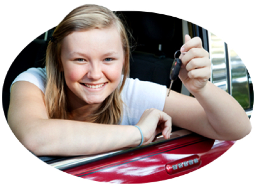 A smiling teen holds up the car keys as a good student reward.