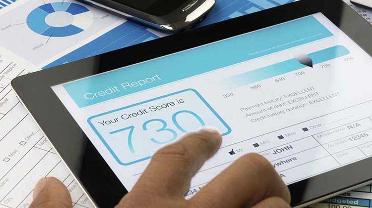 A credit score is displayed on a tablet device