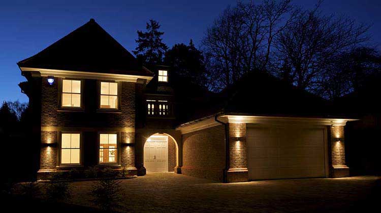 A house at night with interior and exterior lights on