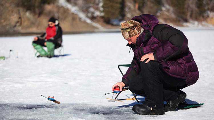 Two people ice fishing