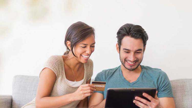 Couple shopping online with a credit card
