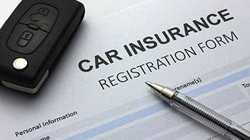 Photo of car insurance form with car keys and a pen
