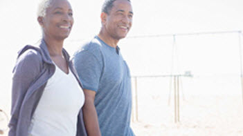 Older couple walking holding hands