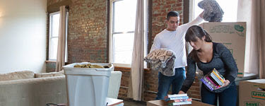 Man and women unpacking boxes
