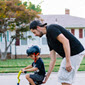 Father teaching his son to ride a bike