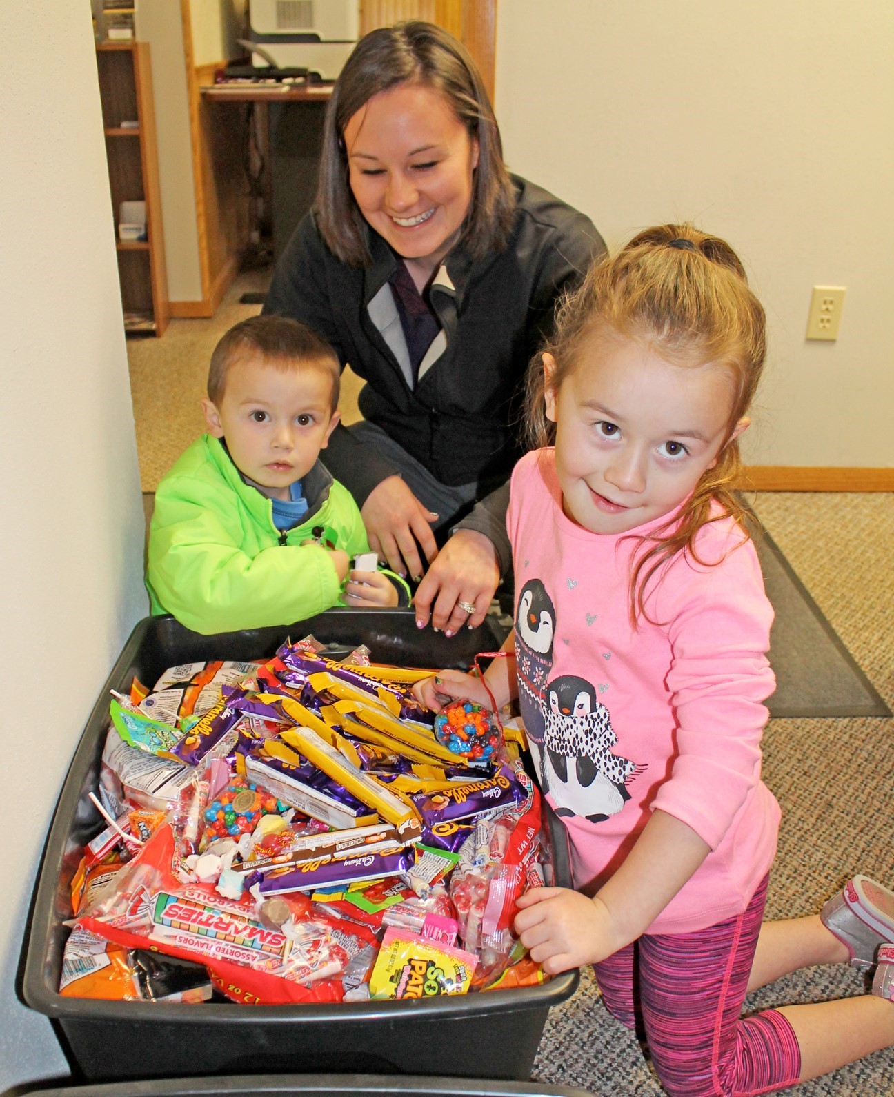 Candy Buy Back: Kids and mom showing their candy.