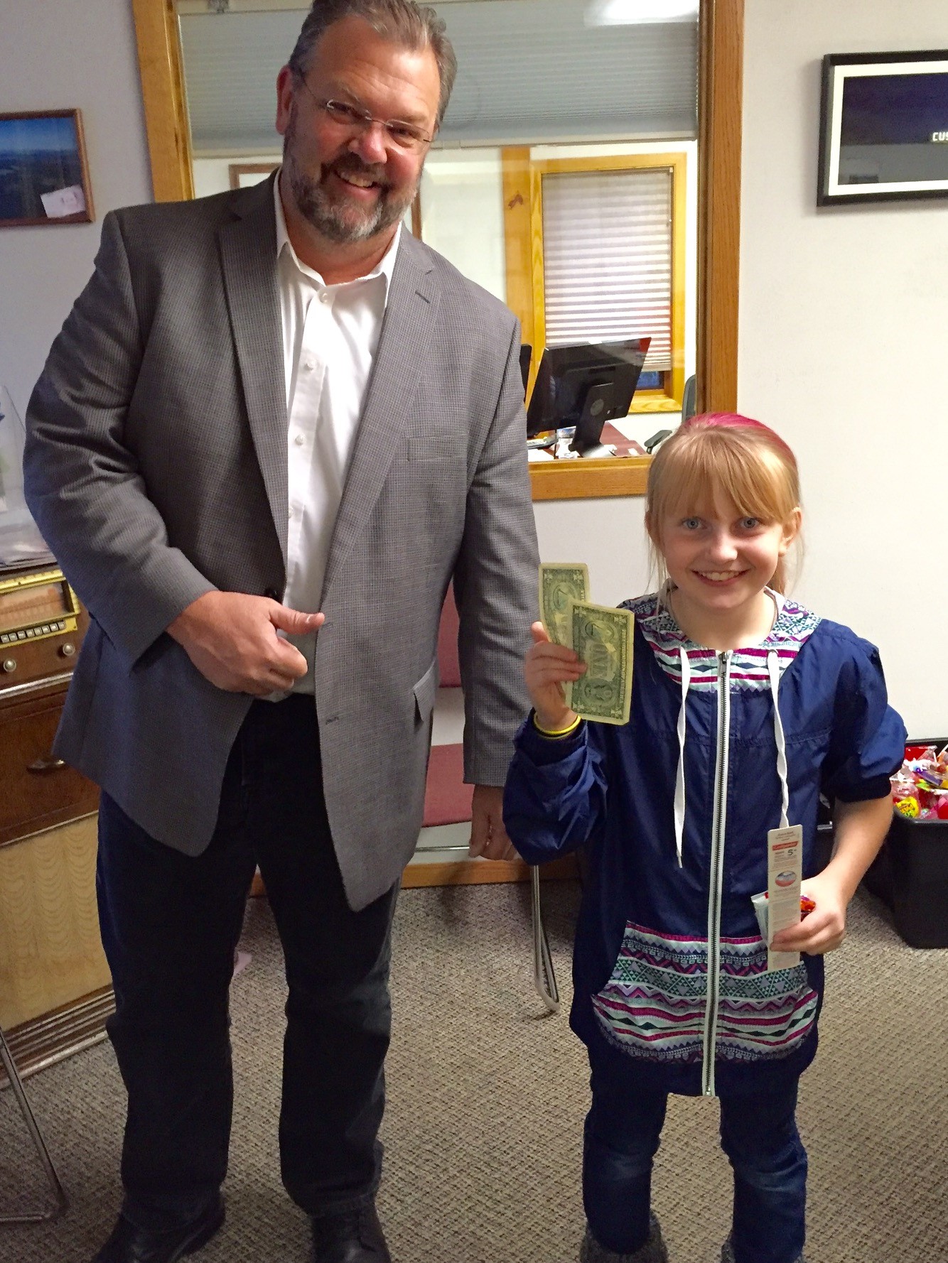 agent and kid holding money