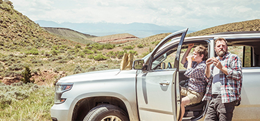 Tourists unloading car in remote landscape