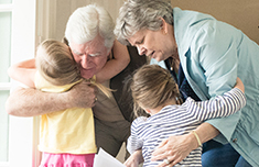 Grandparents hugging grandchildern