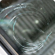 Image showing halfmoon damage to a windshield.