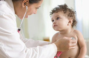 Doctor listening to a child heart with a stethoscope