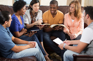 A group of people discussing a book