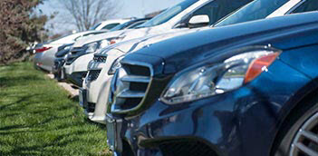Photo panning down a row of the front bumpers of cars