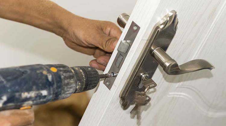 Person installing a door lock
