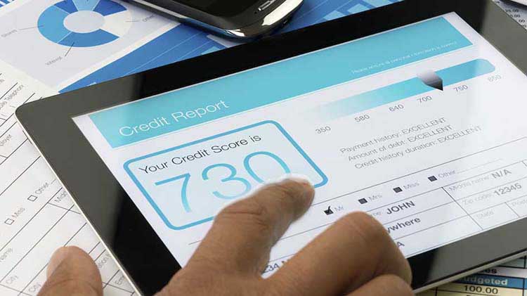 A credit report and credit score are shown on a tablet