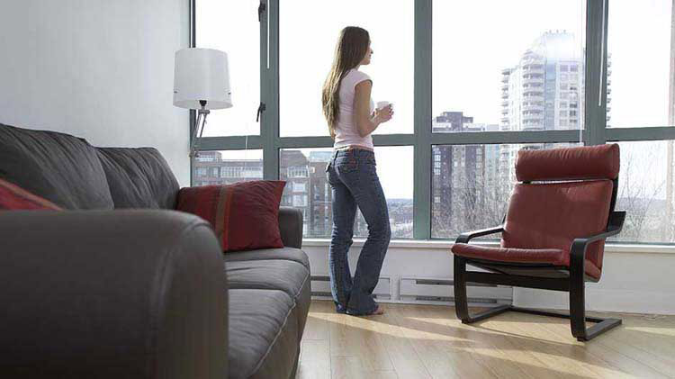 Woman standing at condo window