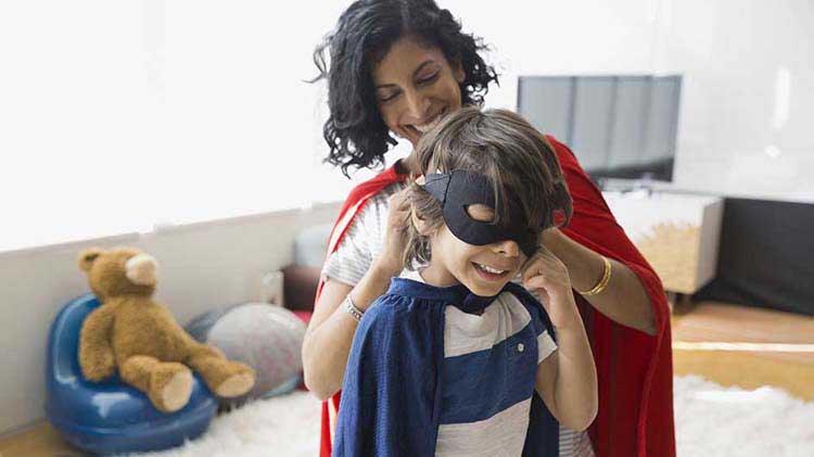 Mom helping her son put on a mask