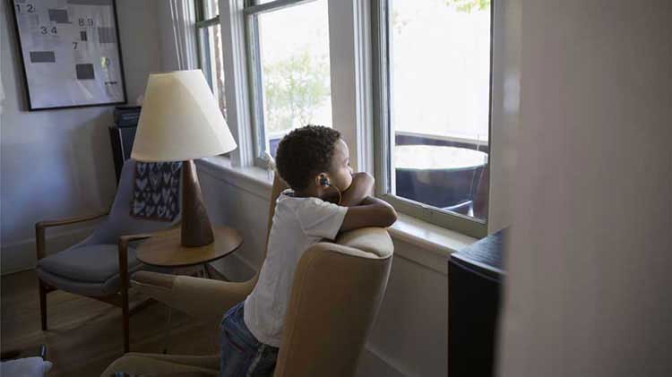 Child looking out a window