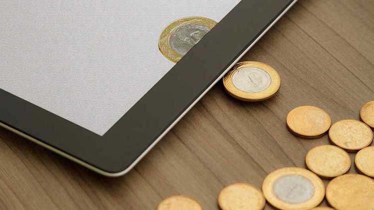 Coins coming out of a tablet device