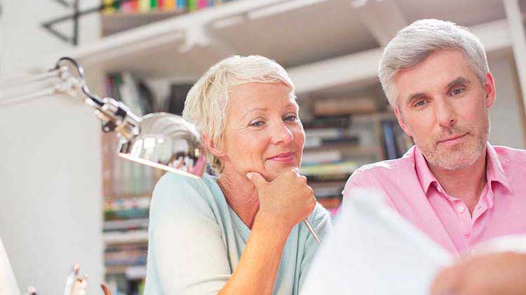 Older couple looks over financial documents