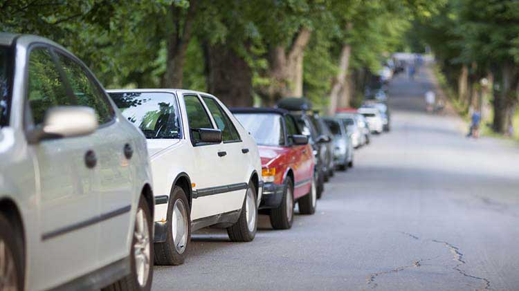 Guests cars are parked along the curb while they attend a house party
