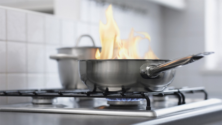 Food burning in pan on stove.
