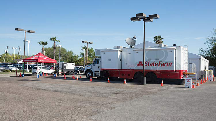 State Farm catastrophe vehicle in a parking lot.