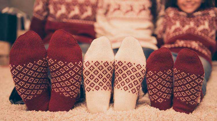 Three pairs of feet in warm cozy socks